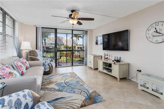 tiled living room with expansive windows and ceiling fan