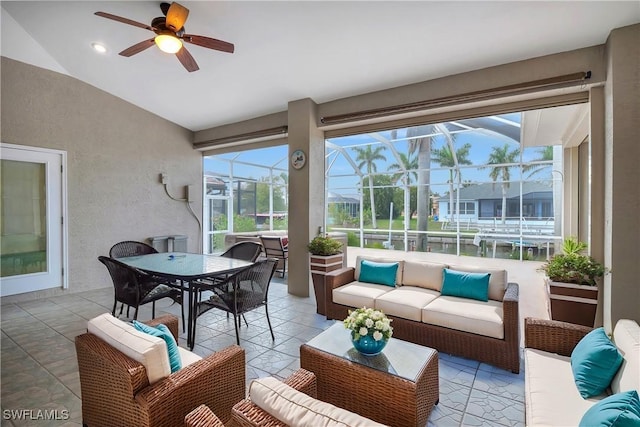 sunroom featuring ceiling fan and vaulted ceiling