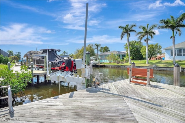 dock area with a water view and boat lift