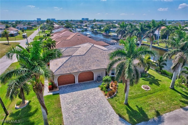 bird's eye view featuring a water view and a residential view