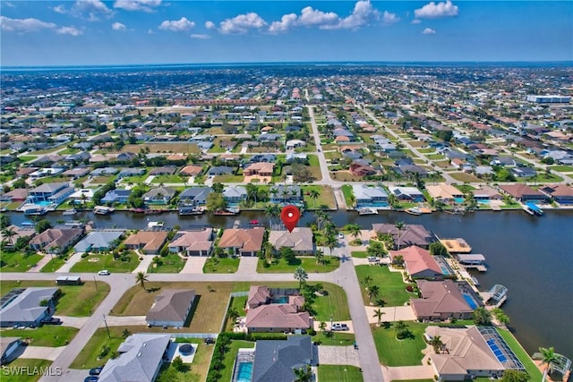 bird's eye view featuring a water view and a residential view