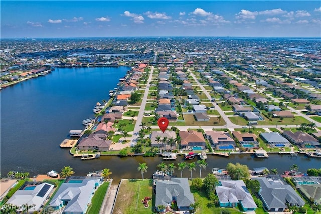 drone / aerial view with a water view and a residential view