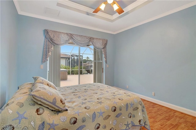 bedroom with access to outside, ornamental molding, wood finished floors, and baseboards