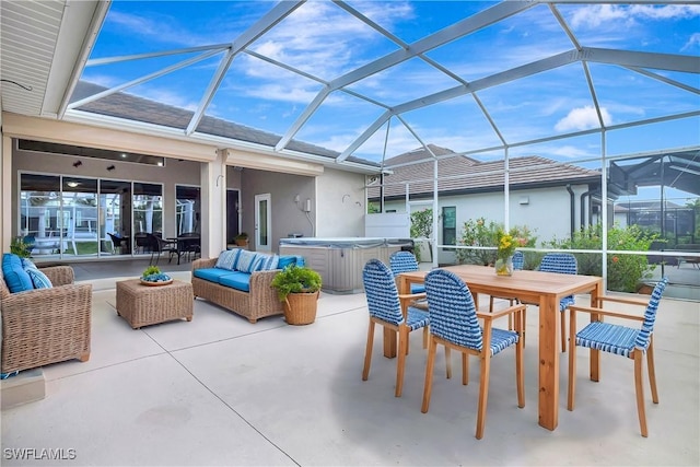 view of patio / terrace with outdoor dining area, a lanai, a hot tub, and an outdoor hangout area