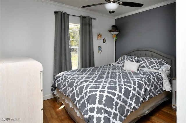 bedroom featuring a ceiling fan, baseboards, ornamental molding, and wood finished floors