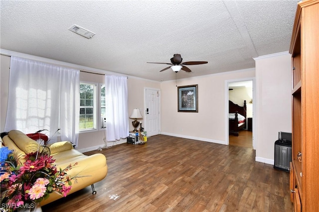 1132 W Red Rd, Labelle, FL 33935 - living area with a ceiling fan, dark wood finished floors, a textured ceiling, ornamental molding, and baseboards