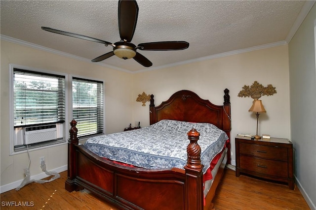 bedroom featuring crown molding, a textured ceiling, cooling unit, and wood finished floors