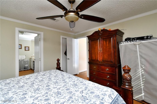 bedroom with a textured ceiling, ornamental molding, visible vents, and a ceiling fan