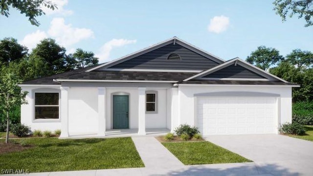 view of front of home with a front yard and a garage