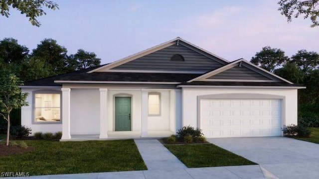 view of front of home featuring a yard and a garage