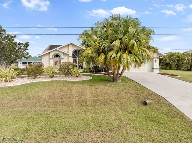 view of front of home featuring an attached garage, driveway, a front lawn, and stucco siding