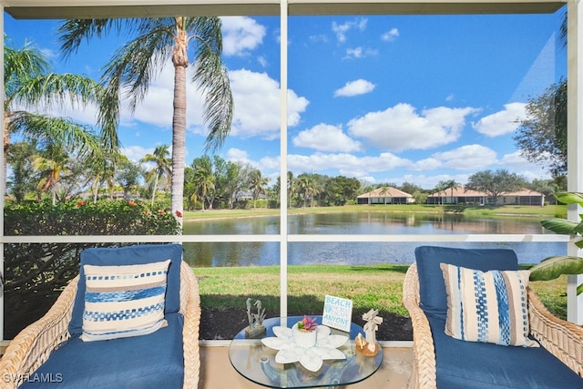 sunroom / solarium featuring a water view