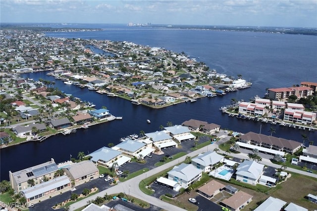 drone / aerial view with a residential view and a water view