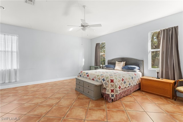 tiled bedroom featuring ceiling fan