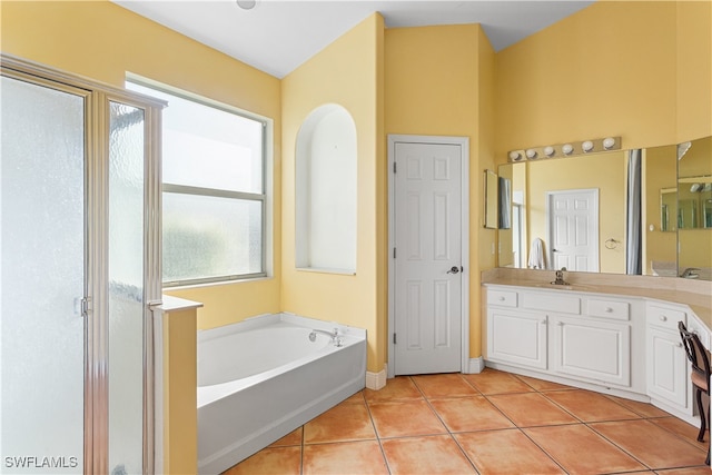 bathroom with plus walk in shower, vanity, and tile patterned flooring