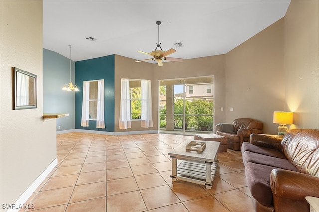 living room featuring ceiling fan with notable chandelier, high vaulted ceiling, and light tile patterned flooring