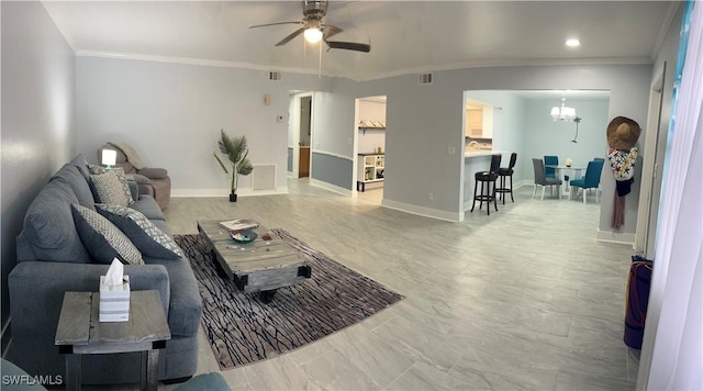 living room with crown molding and ceiling fan with notable chandelier