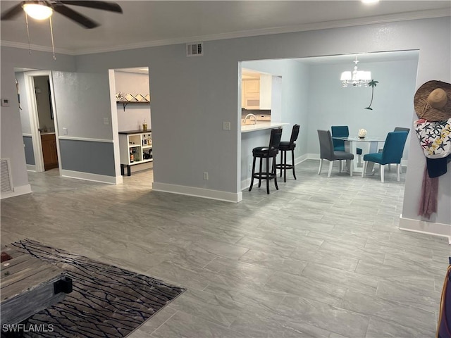 living room with sink, crown molding, and ceiling fan with notable chandelier