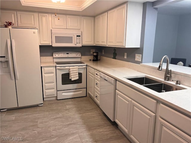 kitchen featuring white appliances, white cabinetry, and sink