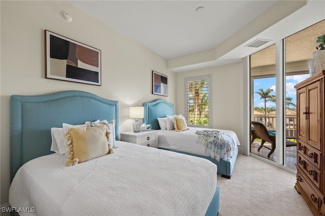 bedroom with access to exterior, light carpet, and visible vents