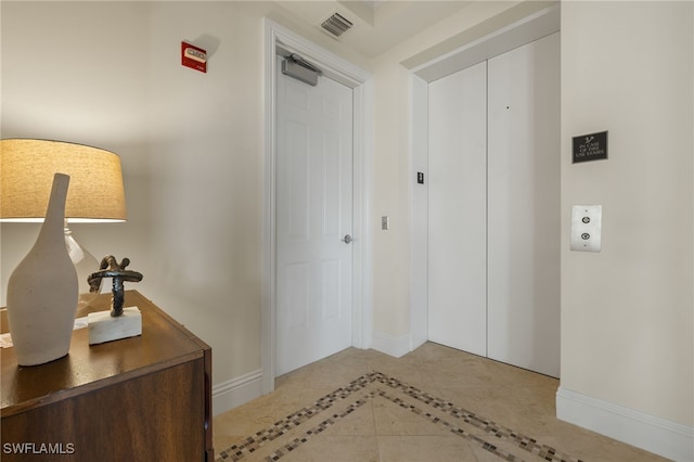 corridor featuring visible vents and baseboards