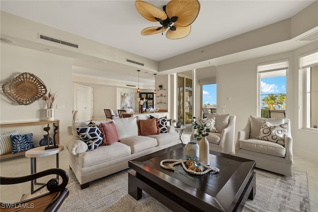 living room with visible vents and a ceiling fan