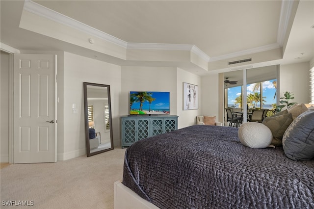 bedroom featuring access to exterior, a tray ceiling, light colored carpet, and crown molding