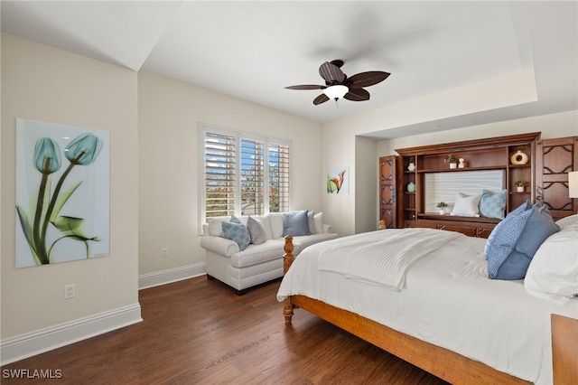 bedroom featuring a ceiling fan, dark wood-style flooring, and baseboards