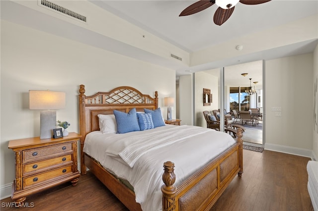 bedroom featuring dark wood-style floors, access to outside, visible vents, and baseboards