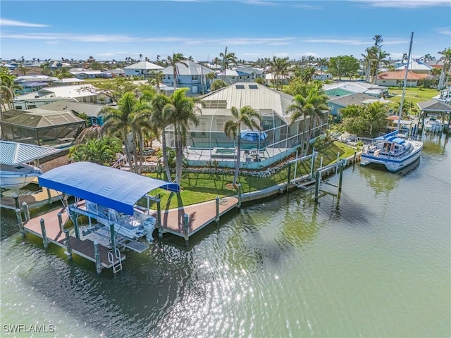 dock area with boat lift, a residential view, a lanai, a water view, and a pool