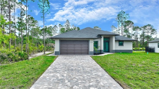 view of front of home with a front lawn and a garage