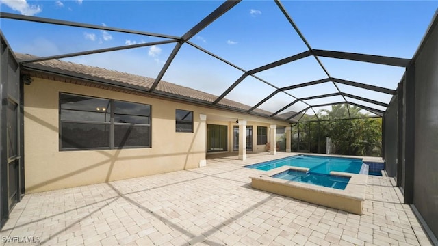 view of swimming pool with a patio, a lanai, and an in ground hot tub