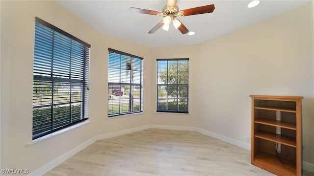 spare room featuring light hardwood / wood-style flooring and ceiling fan