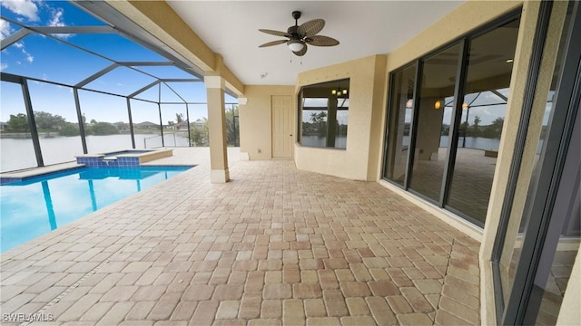 view of pool with a patio area, a water view, an in ground hot tub, ceiling fan, and a lanai