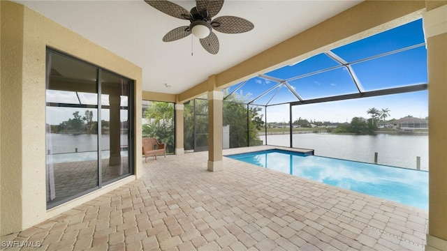 view of swimming pool featuring a lanai, a water view, ceiling fan, and a patio area