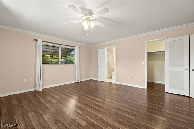 unfurnished bedroom with ceiling fan, a spacious closet, ensuite bath, dark hardwood / wood-style floors, and ornamental molding