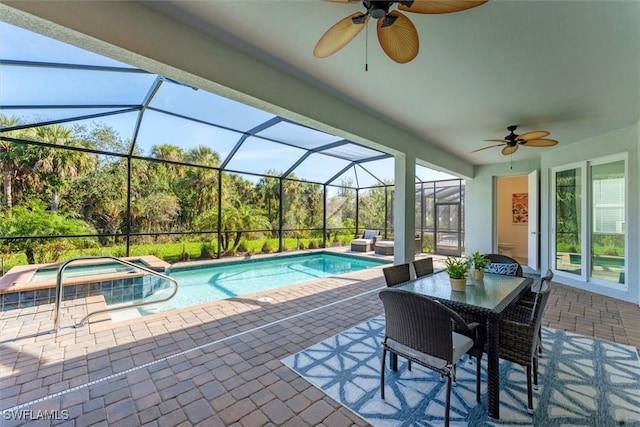 view of pool with glass enclosure, a patio, and ceiling fan