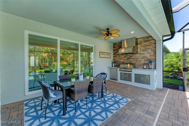 view of patio / terrace with exterior kitchen, area for grilling, and outdoor dining space