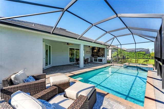 view of pool with a patio, a lanai, area for grilling, a pool with connected hot tub, and a ceiling fan