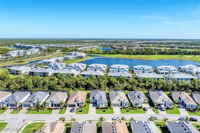 drone / aerial view featuring a water view and a residential view