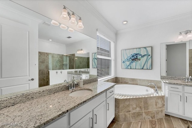 bathroom with crown molding, a sink, a bath, and a walk in shower