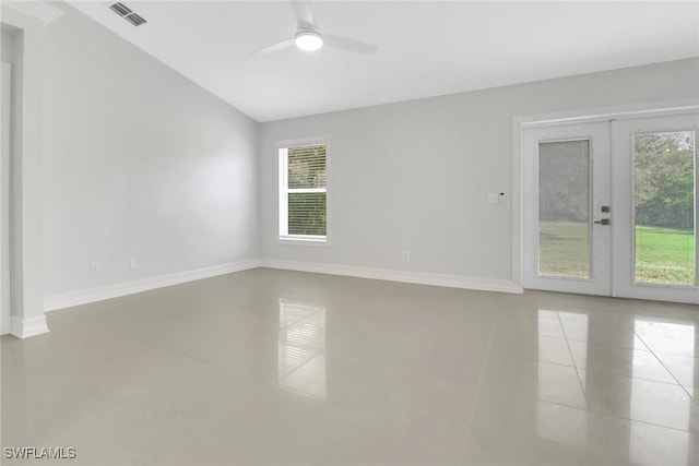 empty room with light tile patterned floors, ceiling fan, visible vents, baseboards, and french doors