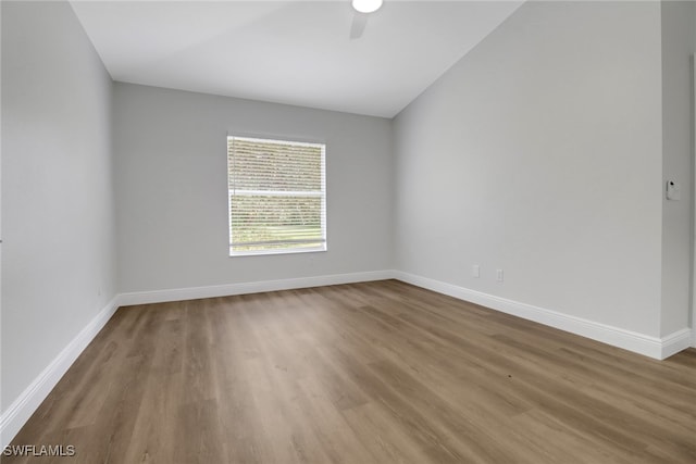 empty room featuring ceiling fan, wood finished floors, and baseboards