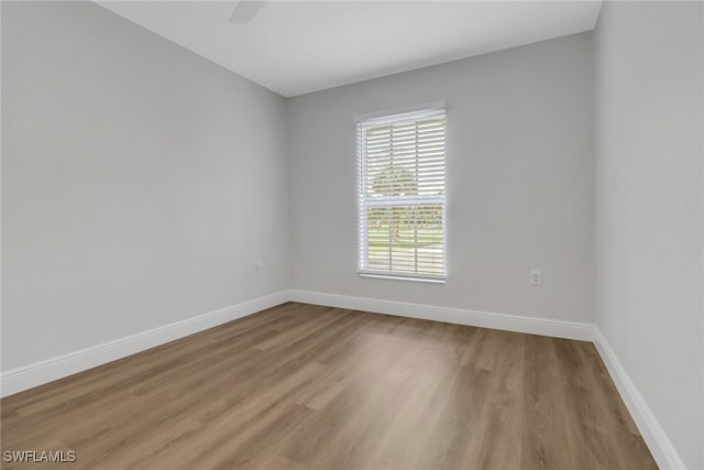 unfurnished room featuring wood finished floors and baseboards