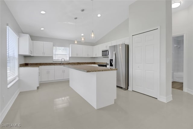 kitchen with pendant lighting, recessed lighting, appliances with stainless steel finishes, white cabinetry, and a kitchen island