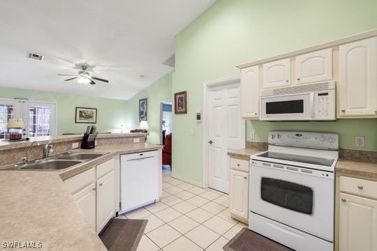 kitchen featuring visible vents, a sink, white appliances, light tile patterned flooring, and ceiling fan