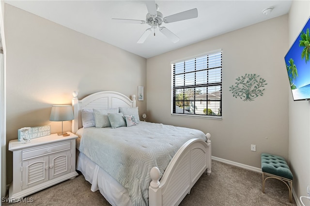 bedroom with light carpet, baseboards, and a ceiling fan