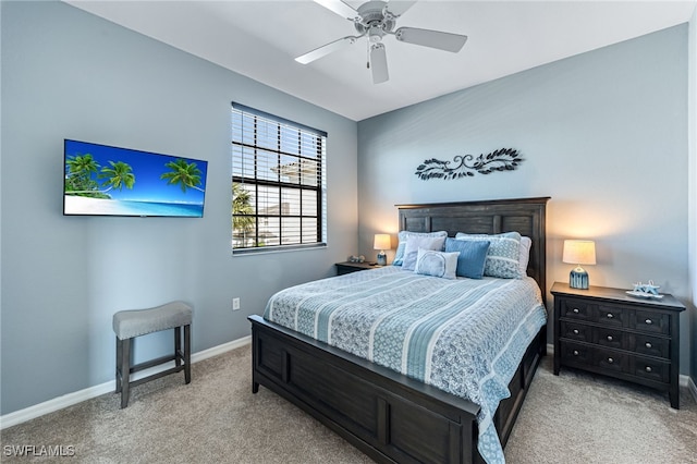 bedroom featuring a ceiling fan, light colored carpet, and baseboards