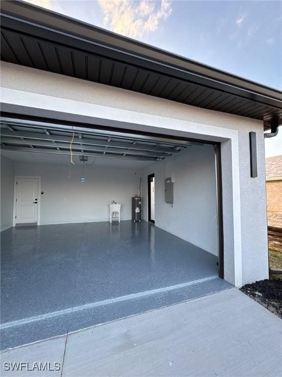 garage featuring water heater and electric panel