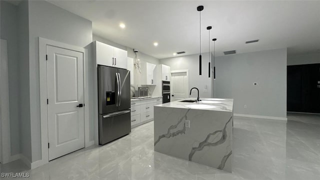 kitchen featuring modern cabinets, marble finish floor, stainless steel fridge, and white cabinets